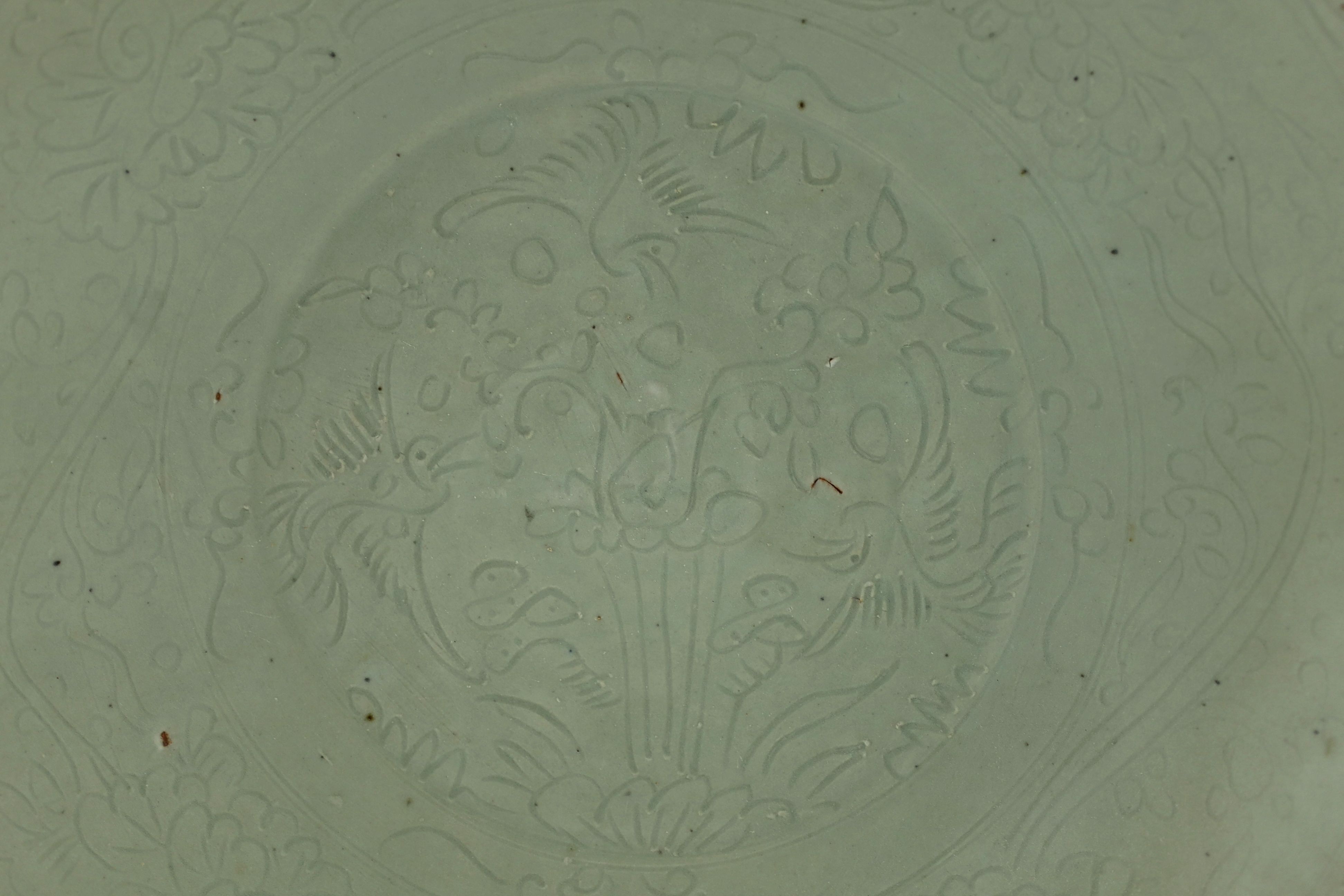 A Chinese celadon glazed sgraffito dish, Zhangzhou kilns, late 16th/early 17th century, 37cm diameter